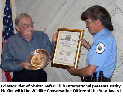 Ed Magruder of Shikar-Safari Club International presents NMDGF Kathy McKim with the Wildlife Conservation Officer of the Year Award
