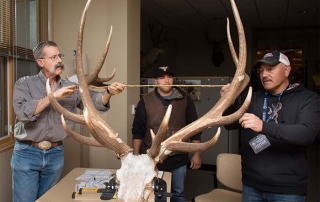 Hunter Joseph Jaramillo (right) with son Jared (center) assist official Boone and Crockett Club Measurer Eric M. Rominger, PhD, Bighorn Sheep Biologist NMDGF.