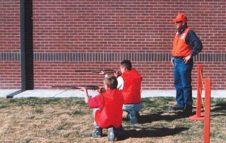 Students demonstrating the proper kneeling position during a sponsored Hunter Education Course from New Mexico Department of Game and Fish.