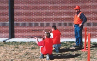 Students demonstrating the proper kneeling position during a sponsored Hunter Education Course from New Mexico Department of Game and Fish.