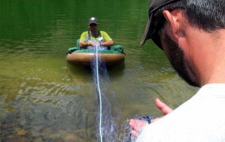 Setting a gill net to survey a timberline lake in the Pecos Wilderness - (New Mexico Game and Fish).