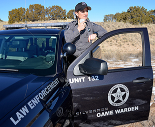 New Mexico Department of Game and Fish game warden on radio