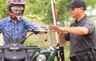 In New Mexico, many people like to recreate using an Off-Highway Vehicle (OHV). OHV Law Enforcement Coordinator Desi Ortiz shows this young man the best ways to be safe while on the trails.