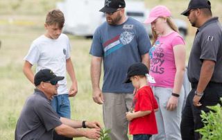 There are more to the skills camp than just shooting firearms. Public Information Specialist Ross Morgan helps this group learn what to do after you shoot an animal.