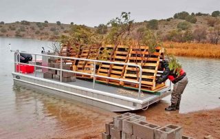 Three pisces pyramids loaded on barge.