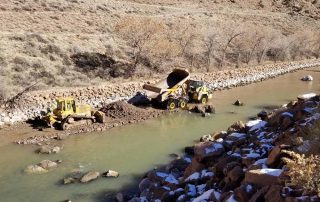 Contractor constructing gravel point bar and low flow channel