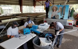 Biologists marking Rainbow Trout with microscopic metal wire tags at Red River State Fish Hatchery in 2020. The machines used to mark fish allowed us to tag many fish (about 200 per hour).